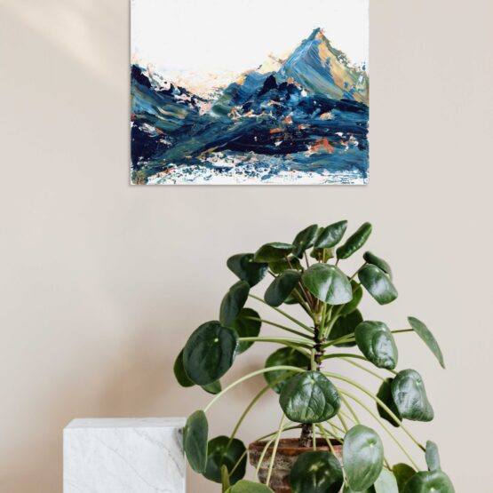 Blue, green and hints of orange and yellow marbled abstract mountain against a wispy white cloudy back ground with bits of blue sky peeking through original painting frameless, hung on a beige wall above a white shelf with a green round leafed plant in a brown woven pot