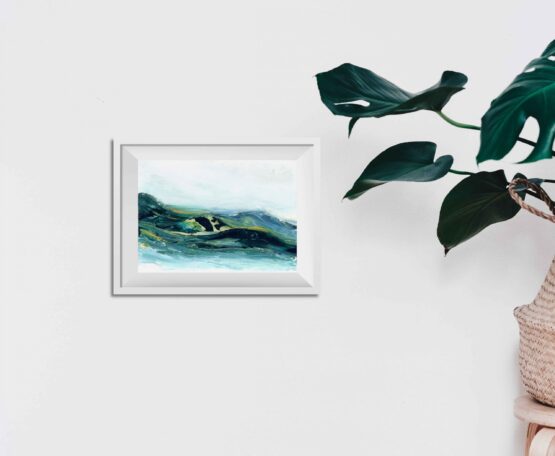 Abstract Mountain Landscape Painting with brlue and green marbled mountains against a white sky and white water, hung on a white wall above a green potted plant