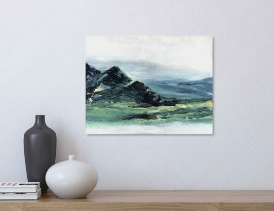 Abstract Mountain Landscape Painting with brlue and green marbled mountains against a white sky and white water, hung on a white wall above a natural wood shelf with a black vase, a white vase and a small stack of books