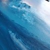 Texture Detail of large landscape painting with textured flowing blue mountains against a lavender and pink sunset sky