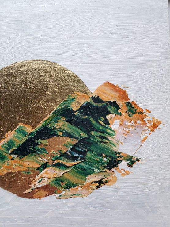 Detail of an abstract landscape painting with brown and green marbled paint in the shape of rugged mountains against a white background and a gold leaf moon.