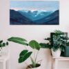 Blue Mountain range of the lions from vancouver bc canada against a lavendar purple and pink sunset sky highly textured acrylic art print on white wall above potted plant in white basket and white chair with a white table and potted plants on it