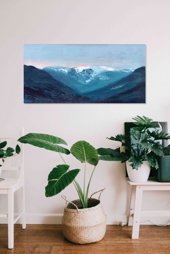 Blue Mountain range of the lions from vancouver bc canada against a lavendar purple and pink sunset sky highly textured acrylic art print on white wall above potted plant in white basket and white chair with a white table and potted plants on it