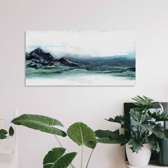 Abstract Mountain landscape print, blue and greens on white wall above plants and a small black photo frame and a white chair