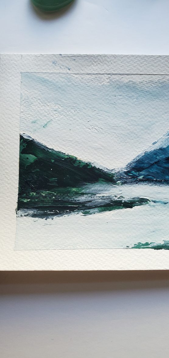 Mist Lake Painting on watercolor paper Blue Mountain range against grey misty skies and grey lake surface below with a dark green forest on the left
