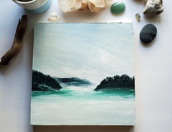 misty lake painting with blue and green mountains and white and blue water