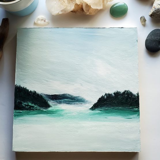 misty lake painting with blue and green mountains and white and blue water